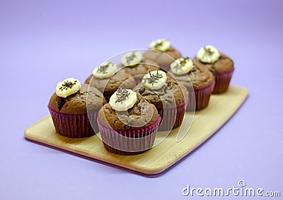 Chocolate banana muffins set on wood board Stock Photo