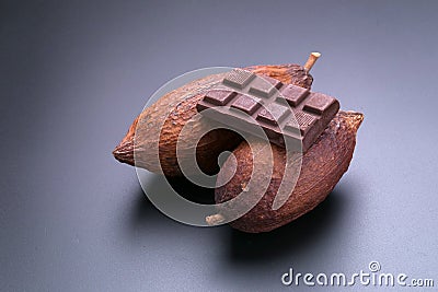 Chocolate bar and dried cocoa pod on black background Stock Photo