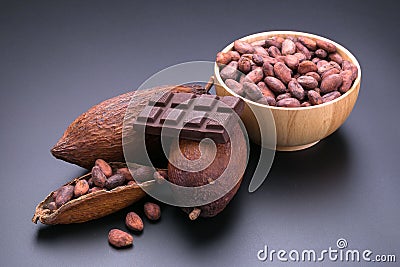 Chocolate bar and dried cocoa pod on black background Stock Photo