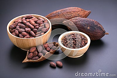 Chocolate bar and dried cocoa pod, cocoa nibs in wooden bowl on Stock Photo