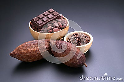 Chocolate bar and dried cocoa pod, cocoa nibs in wooden bowl on Stock Photo