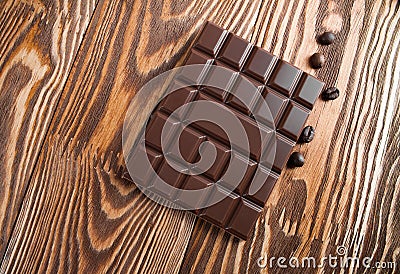 Chocolate bar on a wooden board. Stock Photo