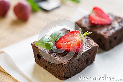 Chocolate brownie cake decorated with strawberries. Selective focus Stock Photo