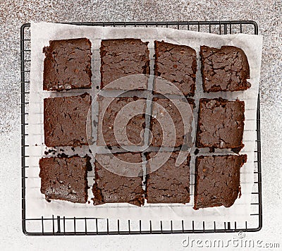 Chocolate brownie cakes on baking rack on grey stone background. Stock Photo