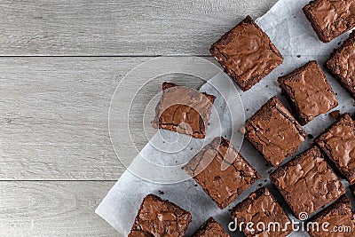 Chocolate brownie on paper on dark grey base top view flat lay Stock Photo