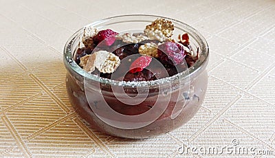 Chocolate budino with dryed raspberries and corn flakes in a glass jar Stock Photo