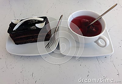 Chocolate cake and berry tea in a cafe Stock Photo