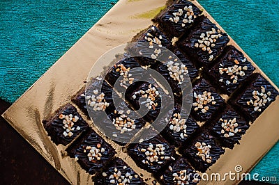 Chocolate Cake Brownie Squares Drizzled With Chocolate Nutella and Walnuts. Stock Photo