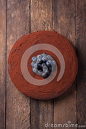 Chocolate cake with cacao powder and blueberries Stock Photo