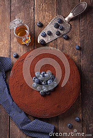 Chocolate cake with cacao powder and blueberries Stock Photo