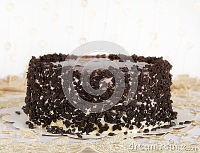 Chocolate Cake with Chocolate, Cake isolated on warm light background with selective focus and uneven light. Concept.Birthday cake Stock Photo