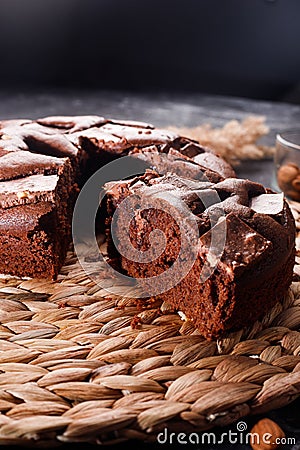 Chocolate cake with chocolate pieces on a metallic black background Stock Photo