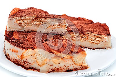 Chocolate cake crackers on isolated white background. Pie sprinkled with cocoa powder on a plate. Chocolate cream pastry cookie, Stock Photo