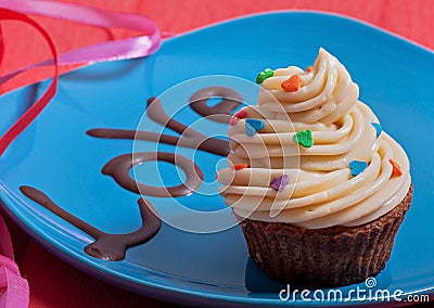 Chocolate cake with creamy cream on a blue plate, with a chocolate inscription love. Stock Photo