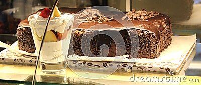 Chocolate cake and ice-cream in the shopwindow Stock Photo