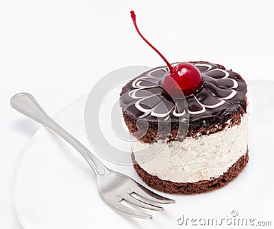 Chocolate cake icing with cherry on the plate isolated Stock Photo