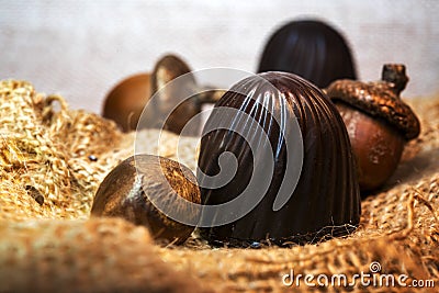 Chocolate candies with nuts on burlap in the sun Stock Photo