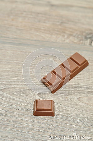 A chocolate candy bar with a piece broken off Stock Photo