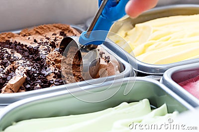 Chocolate chip ice cream being scooped. Surrounded by other flavours Stock Photo