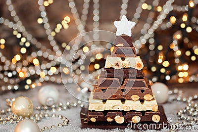 Chocolate Christmas tree in front of booked lights. Selective focus Stock Photo