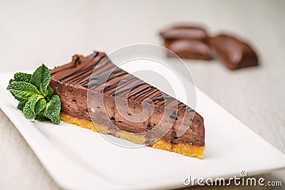 Chocolate or coffee cheescake with mint leaf on white plate, gluten free cake, product photography for patisserie Stock Photo