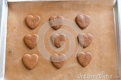 Chocolate cookies on a baking sheet, heart-shaped cookies cooked at home Stock Photo
