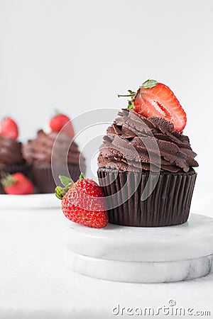 Chocolate cupcake with dark chocolate buttercream and strawberries, double chocolate cupcakes with american buttercream Stock Photo