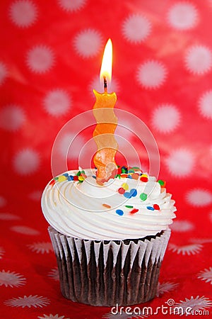 Chocolate cupcake with orange wavy candle Stock Photo