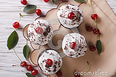 Chocolate cupcakes with cream and cherry closeup horizontal top Stock Photo
