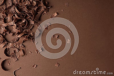 Chocolate curls and space for text on color background, top view Stock Photo