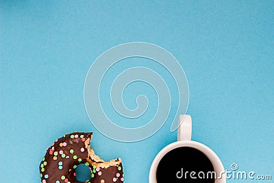 Chocolate donuts with coffee on the blue background. Stock Photo