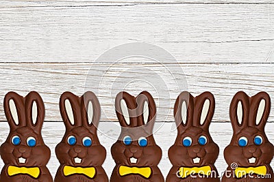 Chocolate Easter Bunnies on grained wood background Stock Photo