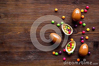 Chocolate eggs - Easter symbol - frame on dark wooden background top-down copy space Stock Photo