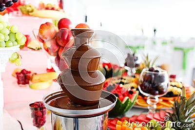 Chocolate Fountain And Fruits For Dessert At Wedding Table Stock Photo