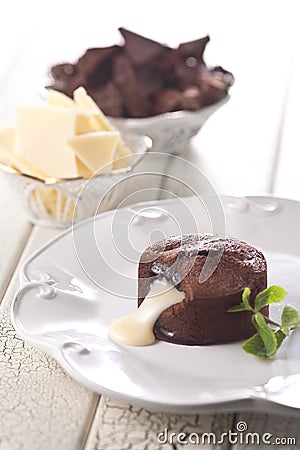 Chocolate fountain, orange cupcake. Photo of food on a white background Stock Photo