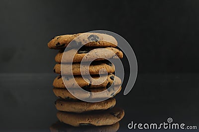 Chocolate homemade holiday cookies with chocolate drops are stacked on top of each other with a reflection side view of copy space Stock Photo