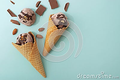 Chocolate ice cream in a waffle cone, blue background, flat lay, top view, copy space. Summer cooling desserts Stock Photo