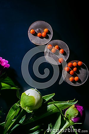 Chocolate kontsety, with peonies, on a dark mirror background Stock Photo