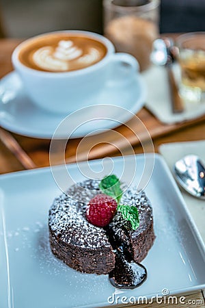 Chocolate lave and raspberry fruit and pepper mint dessert in coffee cafe Stock Photo