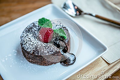 Chocolate lave and raspberry fruit and pepper mint dessert in coffee cafe Stock Photo