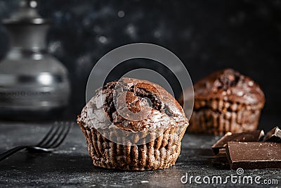 Chocolate muffin on dark background, closeup. Homemade delicious chocolate muffins on black board Stock Photo