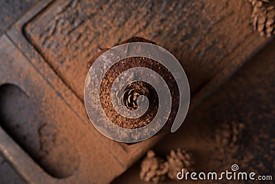 Chocolate muffins, decorated with a small cone on a dark wooden background. Cupcakes are poured with dark chocolate and cocoa powd Stock Photo