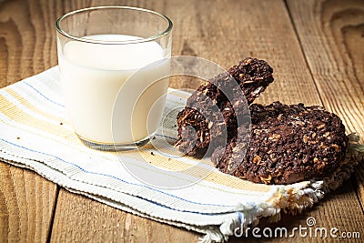 chocolate oatmeal coolies and glass of milk on woden table Stock Photo