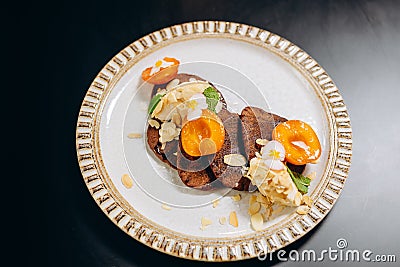 Chocolate pancakes with apricots and almond shavings Stock Photo