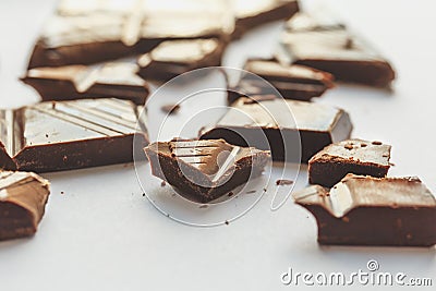 Chocolate pieces on white, selective focus, macro perspective Stock Photo