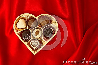 Chocolate pralines in golden heart shape box Stock Photo