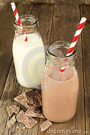 Chocolate and regular milk in bottles on wood Stock Photo