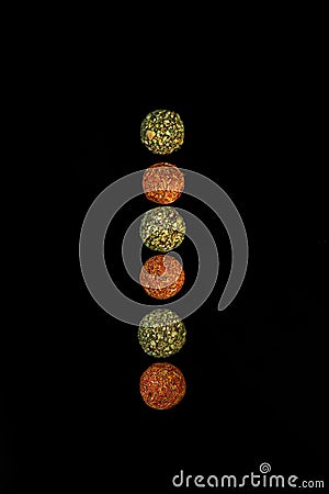 Chocolate round candies sprinkled with spices on a dark background Stock Photo