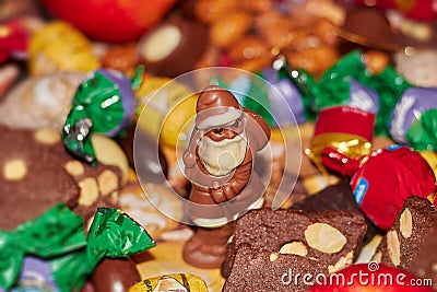 Chocolate Santa Claus wanders through sweets, biscuits and gingerbread Stock Photo