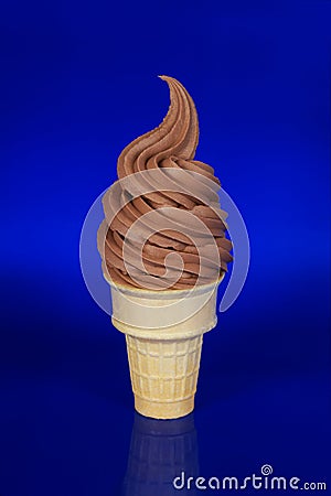 Chocolate Soft Serve Ice Cream on a Blue Background Stock Photo